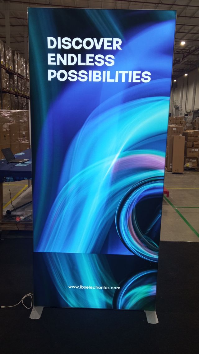 An illuminated display with a flowing pattern in blues and purples. The display says "Discover Endless Possibilities."