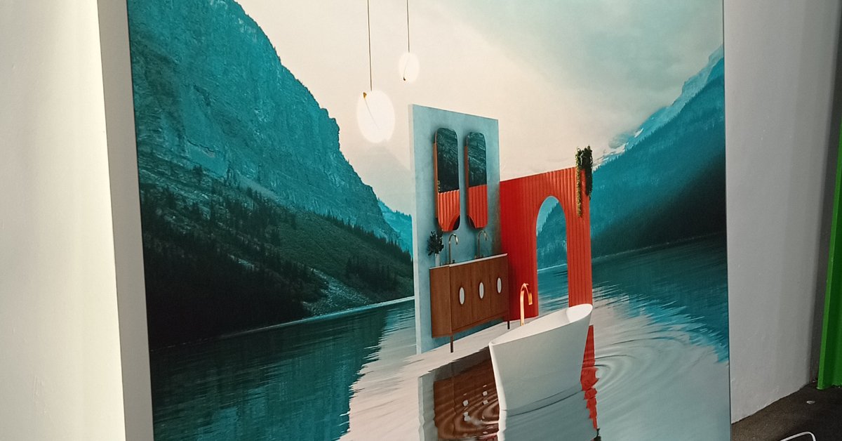 A wall mural showing mountains and water behind a display with red panels, pendant lights, and a floor.